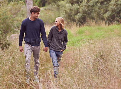 Buy stock photo Happy couple, walk and holding hands in the countryside, forest or summer outdoor for hiking on valentines day date. Smile, man and woman in nature for support, love or romantic connection together