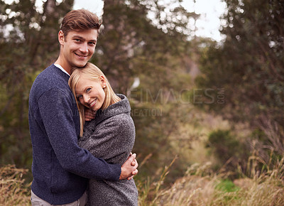 Buy stock photo Couple, portrait and smile with hug outdoor in countryside for holiday, vacation or anniversary getaway in forest. Love, man and woman with face, happy and embrace in woods for relationship or mockup