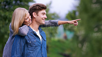 Buy stock photo Couple, smile and happiness with pointing finger in park, outdoor setting and bonding with activities. Relationship, goals and romance with fun day in forest for lifestyle, wellness and relax