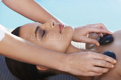 Buy stock photo Sleeping, hot stone or hands with woman in spa for wellness, treatment or hospitality. Relax, resort or salon with female person, client or masseuse in hotel on holiday vacation for beauty therapy