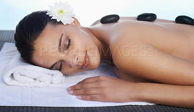 Buy stock photo A beautiful woman receiving a hot stone massage