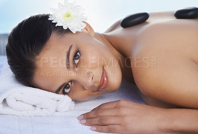 Buy stock photo Sleeping, hot stone or woman in spa with smile or flower for wellness, treatment or hospitality. Relax, resort or healing therapy for happy person, client or masseuse in hotel on holiday vacation