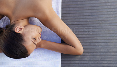 Buy stock photo A gorgeous young woman lying on her front at a spa