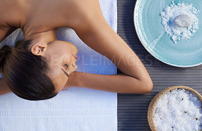 Buy stock photo A beautiful young woman lying on her front at a spa