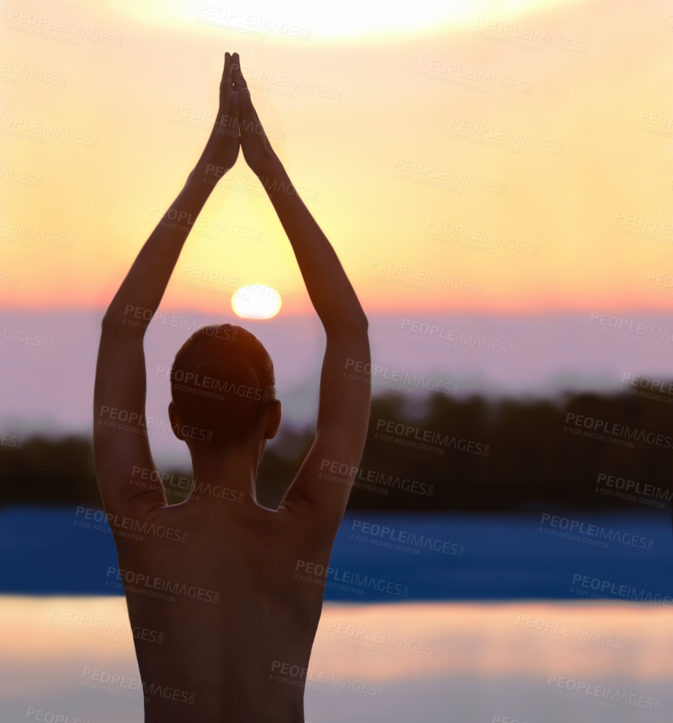 Buy stock photo A beautiful young woman in a yoga pose at sunset