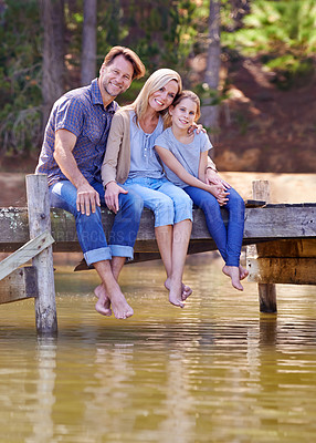 Buy stock photo Portrait, lake and girl with family, smile and happiness with water or nature with vacation or getaway trip. Parents, hug or mother with father or child in a forest or holiday with boardwalk or relax