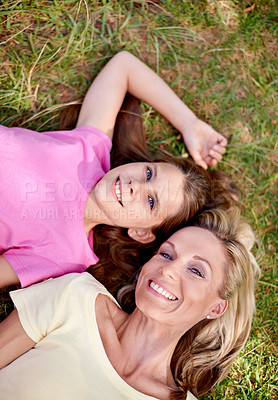 Buy stock photo Mother, daughter and portrait on grass with happiness for bonding, support or aerial view on holiday in nature. Family, woman and girl child with face, smile or relax on vacation and travel with love