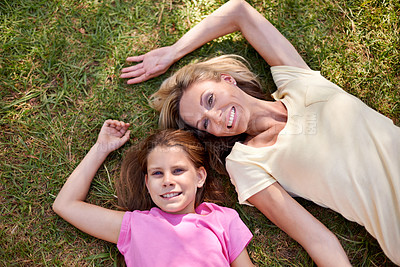 Buy stock photo Mother, daughter and portrait on grass with smile for bonding, support or aerial view on holiday in nature. Family, woman and girl child with face, happiness or relax on vacation and travel with love