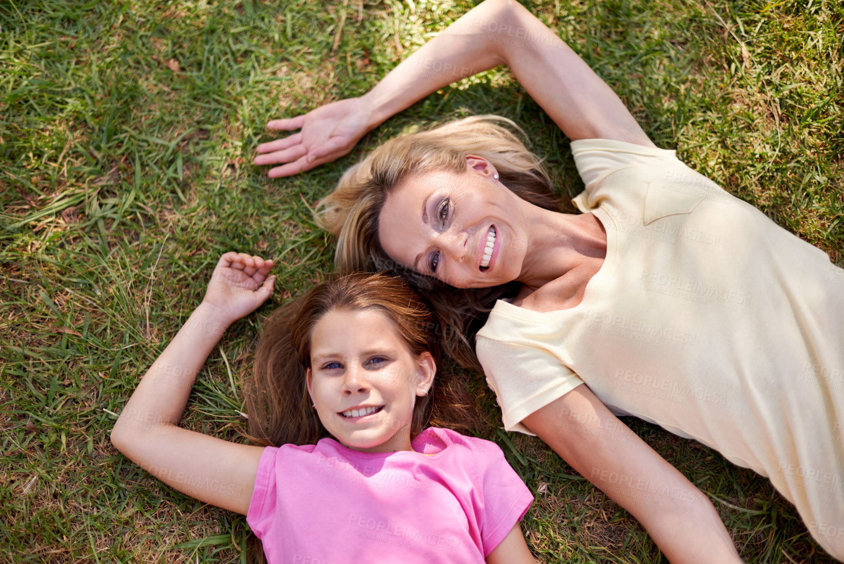 Buy stock photo Mother, daughter and portrait on grass with smile for bonding, support or aerial view on holiday in nature. Family, woman and girl child with face, happiness or relax on vacation and travel with love