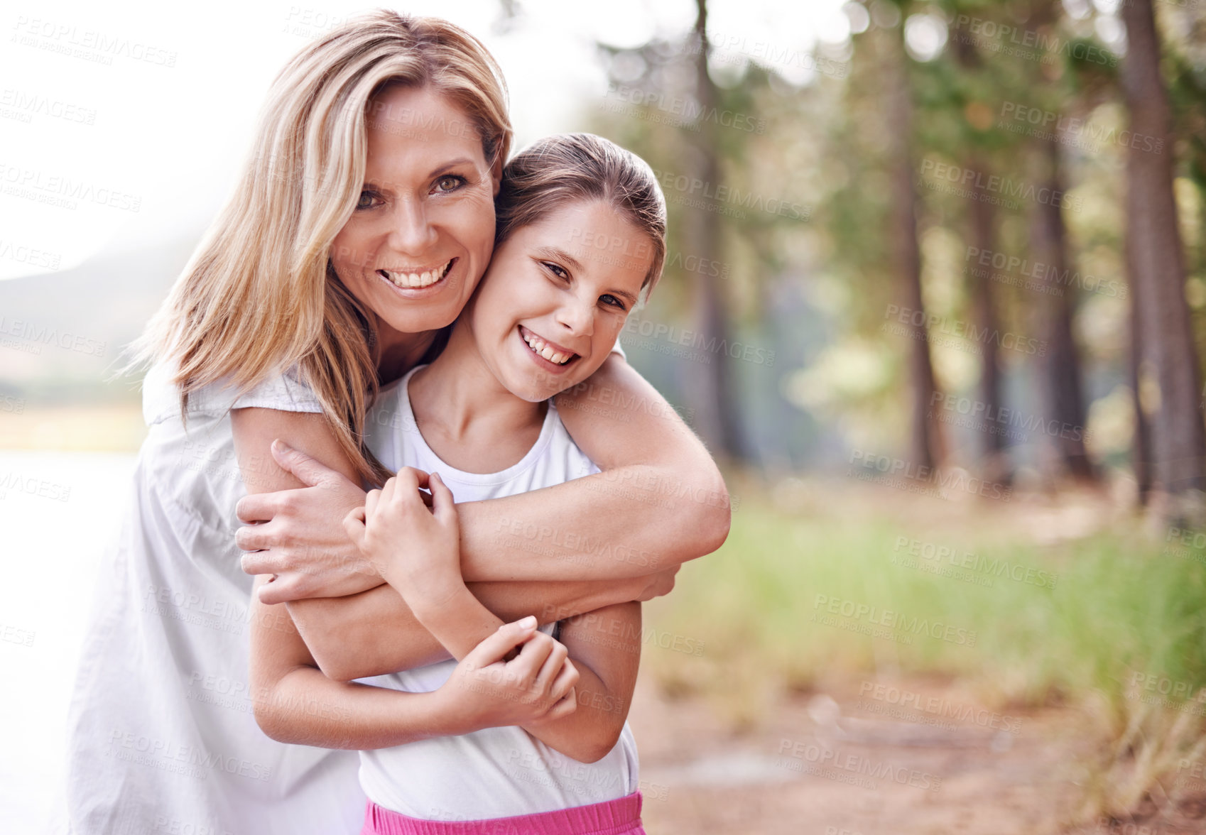 Buy stock photo Mother, daughter and portrait in forest with happiness for bonding, support and hug on holiday in nature. Family, woman and girl child with face, smile and embrace on vacation, travel and adventure