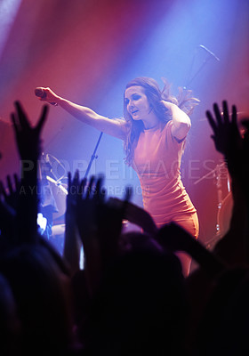 Buy stock photo People hands, singer woman and concert at night performance, singing and gen z in lights, celebration or cheers. Musician person on stage and microphone at event with fans, crowd or audience dancing