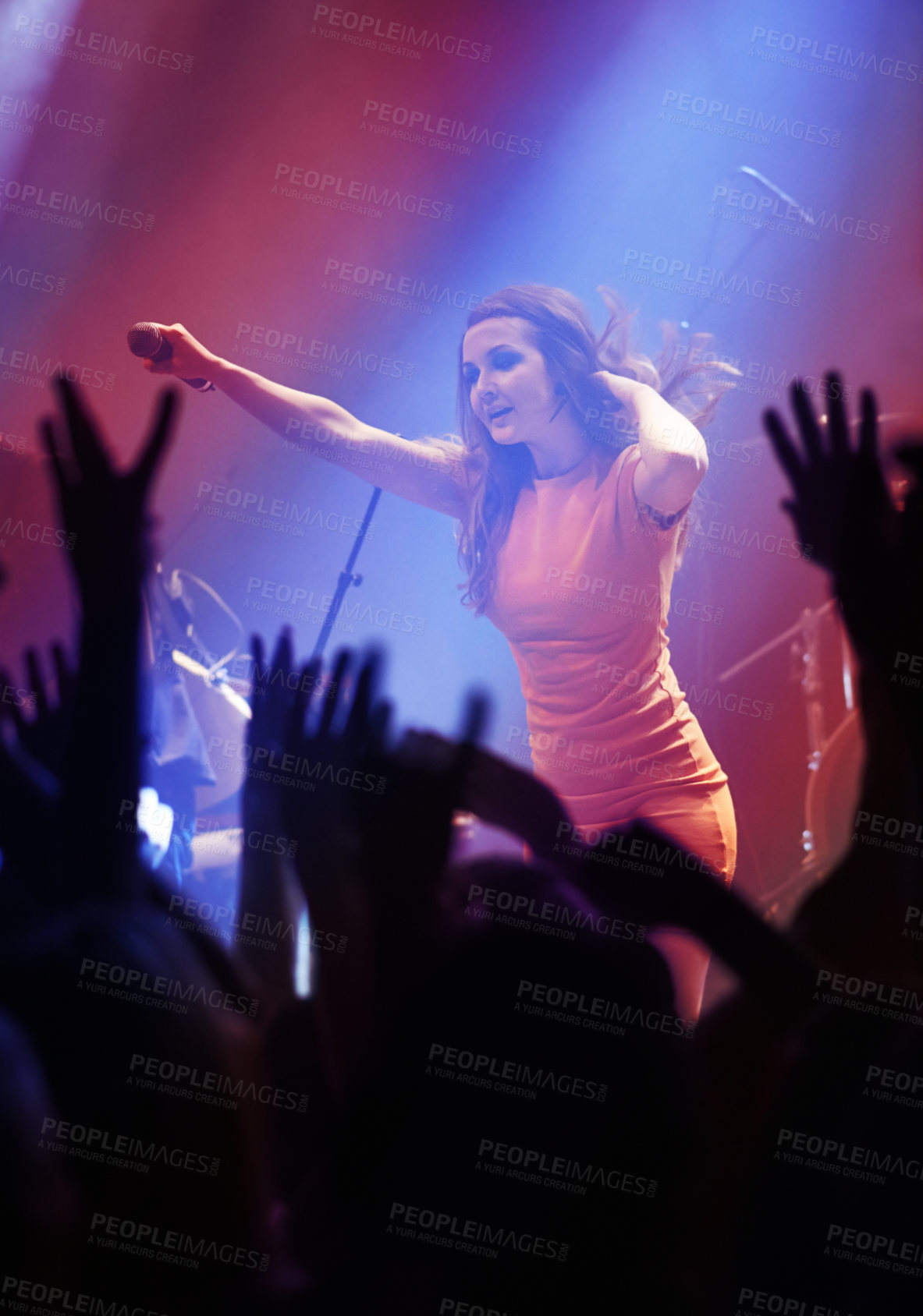 Buy stock photo People hands, singer woman and concert at night performance, singing and gen z in lights, celebration or cheers. Musician person on stage and microphone at event with fans, crowd or audience dancing