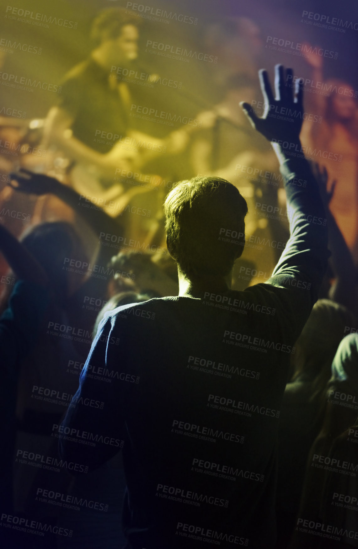 Buy stock photo Concert, singing and people dancing to music at night performance, rock and gen z singer in lights and cheers. Musician on stage at disco event and fans rear, crowd or audience with man hands in air
