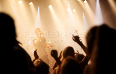 Buy stock photo Music festival, concert or people singing at night performance for gen z party, nightclub lights and dancing. Rock band on stage at event with crowd dance, audience group or fans energy in silhouette