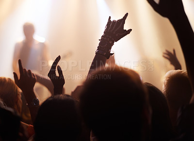 Buy stock photo Crowd, rock and people at a concert for a band, performance and event at night. Party, celebration and group of fans at a music festival for a show, live entertainment and watching a musician