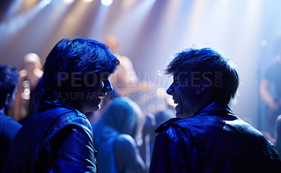 Buy stock photo Excited men, friends and fans at music festival, lights and crowd in silhouette at live band performance on stage. Happiness, people with smile and blue lighting, excitement at rock concert together.