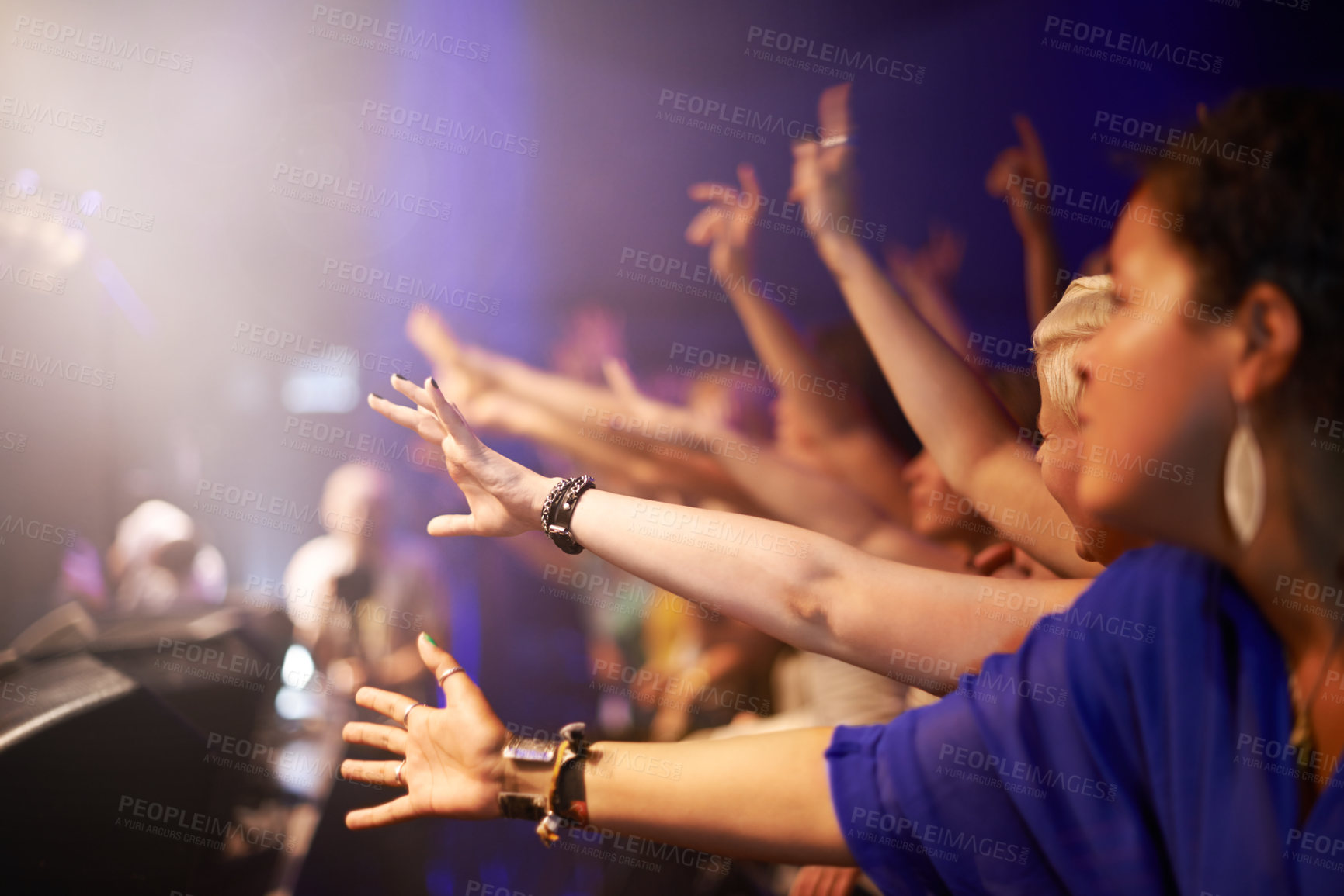 Buy stock photo Fans in front row at concert, hands out and excited music festival audience at rock show. People in crowd at band performance at arena, stadium or party with happiness and energy at night stage event