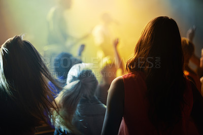 Buy stock photo Music concert, crowd and people singing at night performance for gen z festival with party lights, dancing and cheers. Rock band on stage at event and crowd dance, audience rear or women fans