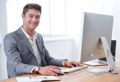 Buy stock photo A handsome young executive working in his office