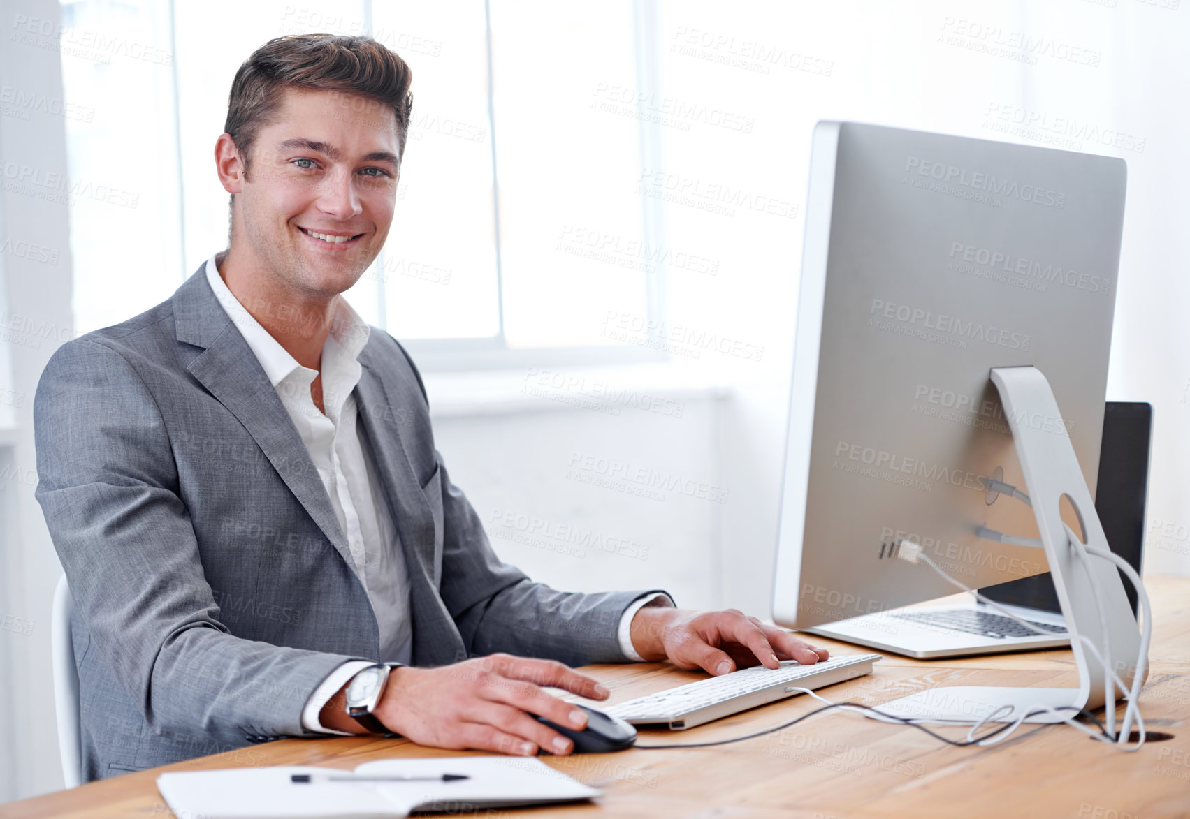 Buy stock photo A handsome young executive working in his office