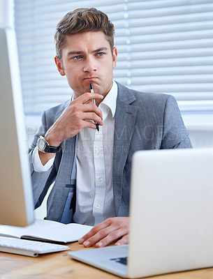 Buy stock photo A handsome young businessman working in his office