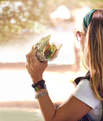 Buy stock photo Hand, fast food and woman eating burger closeup outdoor for hunger, takeaway or craving in summer. Hamburger, lunch or snack with hungry young person holding a fresh beef bun for cuisine or meal