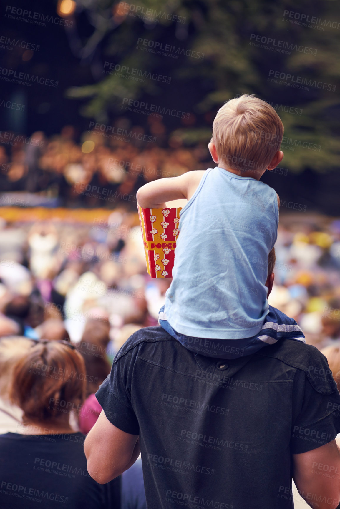 Buy stock photo Back, festival and a boy sitting on dad shoulders outdoor at a music concert together for bonding or entertainment. Family, kids and crowd with a father carrying his child son outside at an event