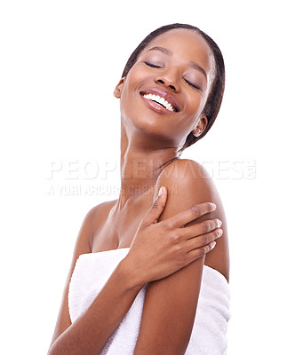 Buy stock photo Black woman, smile and skincare in studio for wellness, glow or feminine grooming in towel. Face, happy and cosmetics with hand on arm pose for beauty, makeup or facial treatment on white background