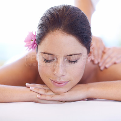 Buy stock photo Relax, massage and face of woman at spa with smile, flower for health with luxury holistic treatment. Self care, peace and girl on table with masseuse for body therapy, wellness and hotel service