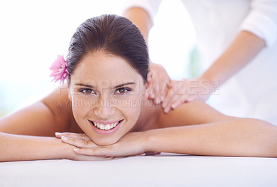 Buy stock photo Relax, massage and portrait of woman at hotel with flower for health, wellness or luxury holistic treatment. Self care, peace and girl on bed with masseuse for body therapy, smile or calm spa service
