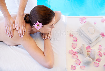 Buy stock photo Flowers, massage and woman at spa pool for health, wellness and luxury holistic treatment. Self care, peace and girl on table with masseuse for body therapy, relax and calm hotel service with petals