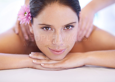 Buy stock photo Relax, massage and portrait of woman at spa with smile, flower for health with luxury holistic treatment. Self care, peace and girl on table with masseuse for body therapy, wellness and hotel service