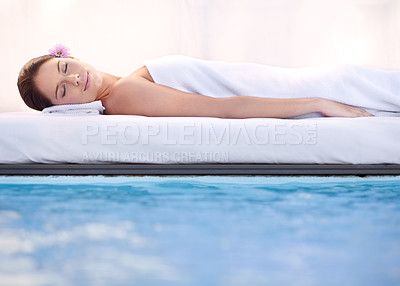 Buy stock photo Relax, sleep and woman at spa pool with massage for health, wellness balance and luxury holistic treatment. Self care, peace and girl on poolside bed for body therapy, comfort and calm hotel service