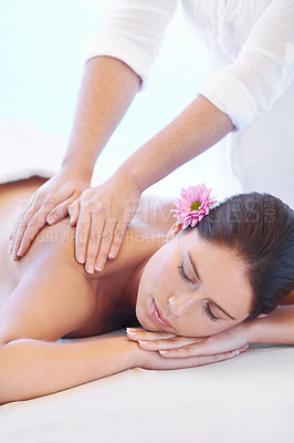 Buy stock photo Calm, massage and woman at wellness spa with flower for health, relax and luxury holistic treatment. Self care, peace and girl on table with masseuse for body therapy, balance and hotel service.