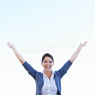 Buy stock photo An attractive young woman raising her hands in celebration
