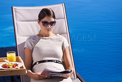 Buy stock photo Woman, reading and magazine on sunbed outdoor with sunglasses for relax, snacks and lifestyle news. Person, publication and paper by pool on holiday, vacation and summer trip at hotel or mockup space