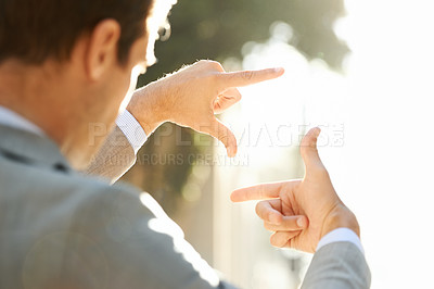 Buy stock photo Hand, frame and closeup of business man in city for vision, focus and thinking with mockup. Inspiration, planning and idea with male employee and finger gesture for freedom, motivation and insight 