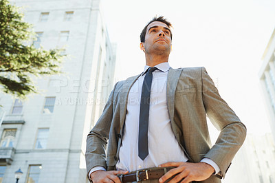 Buy stock photo Professional man, city and buildings with pose for thinking, ideas or vision in Los Angeles. Business person, entrepreneur and confidence outdoors for opportunity, mindset and ambition from low angle