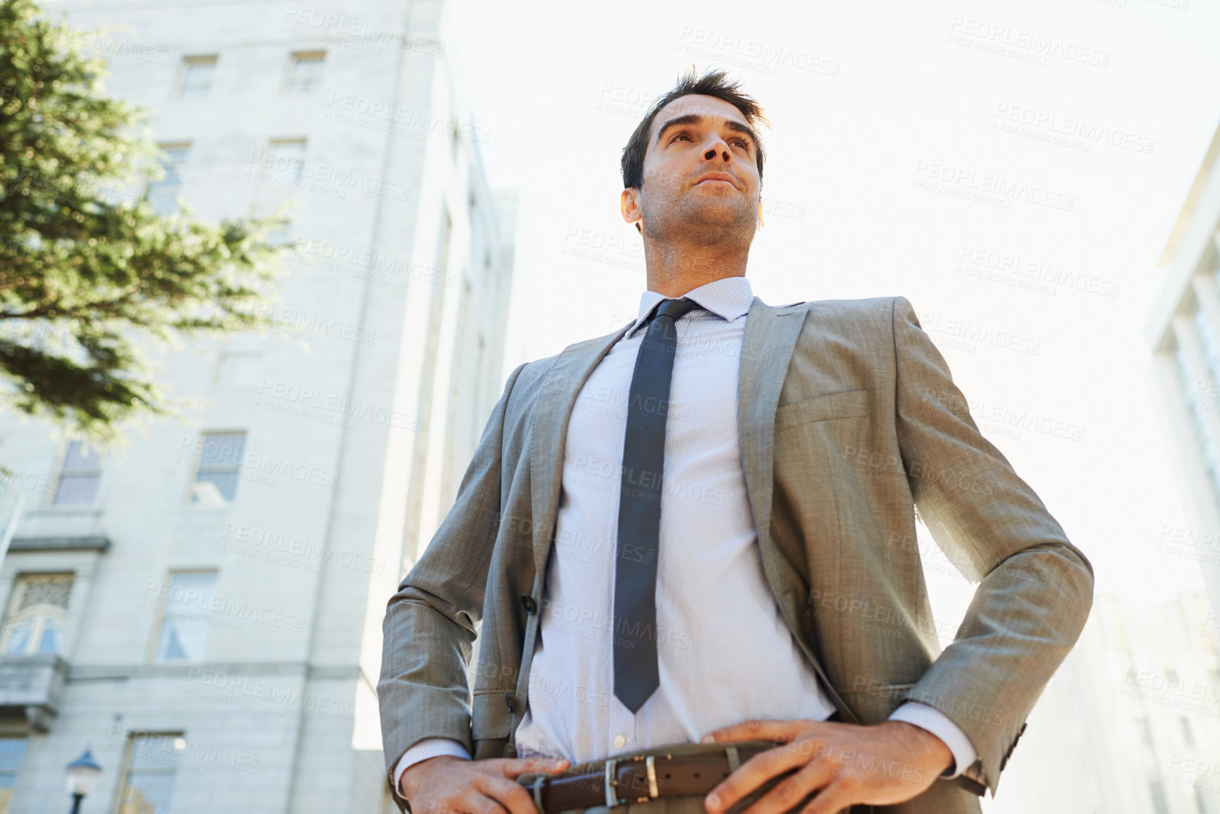 Buy stock photo Professional man, city and buildings with pose for thinking, ideas or vision in Los Angeles. Business person, entrepreneur and confidence outdoors for opportunity, mindset and ambition from low angle