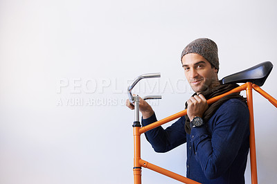 Buy stock photo Bicycle, portrait and man in building carrying bike for healthy and eco friendly transportation for travel. Mockup, smile and cyclist with apartment complex, confidence and journey for travel commute