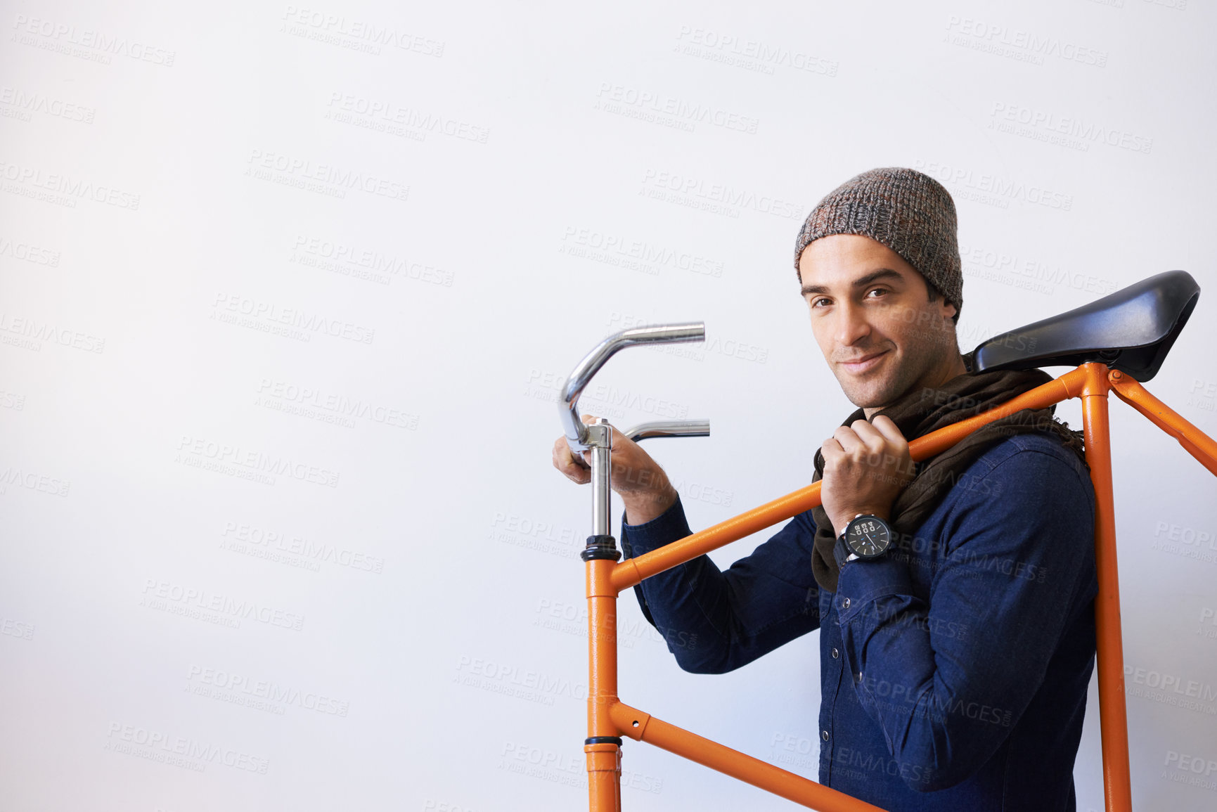 Buy stock photo Bicycle, portrait and man in building carrying bike for healthy and eco friendly transportation for travel. Mockup, smile and cyclist with apartment complex, confidence and journey for travel commute