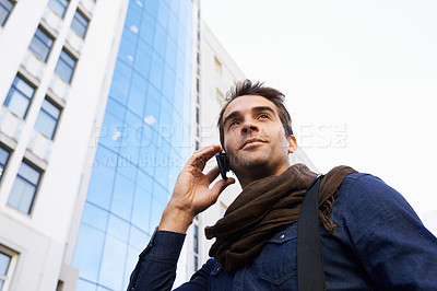 Buy stock photo Man, city and buildings with smartphone for phone call, conversation or networking in Chicago. Male person, technology and smile with communication, contact and happy in morning from low angle