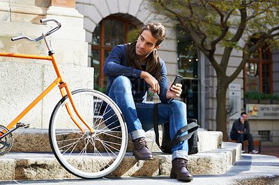 Buy stock photo Man in city, bicycle and cellphone with travel, carbon footprint and communication with tech and cycling. Eco friendly transportation, using phone for location and connectivity for journey with bike