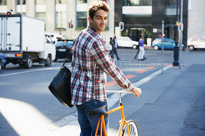 Buy stock photo Portrait of a handsome man traveling by bicycle in the city