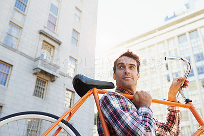 Buy stock photo Man, lifting bicycle and smile for travel, commute or journey to apartment in Chicago from behind. Male person, happy and road bike for sustainability, environmentally friendly and mobility in city