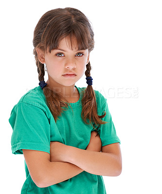 Buy stock photo Studio portrait of a little girl looking sullen while standing with her arms crossed
