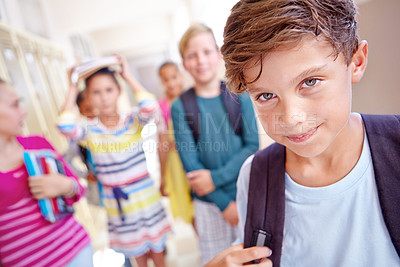 Buy stock photo Students, portrait and boy with smile in hallway with education, study or backpack for back to school. Youth, young kid and learning with friends on campus with children and happy after class and fun