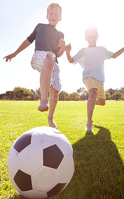 Buy stock photo Kids, soccer ball and field outdoor with fun, bonding and summer play with smile from sport. Running, happy and game with young children on a lawn for match with friends or sibling with football 