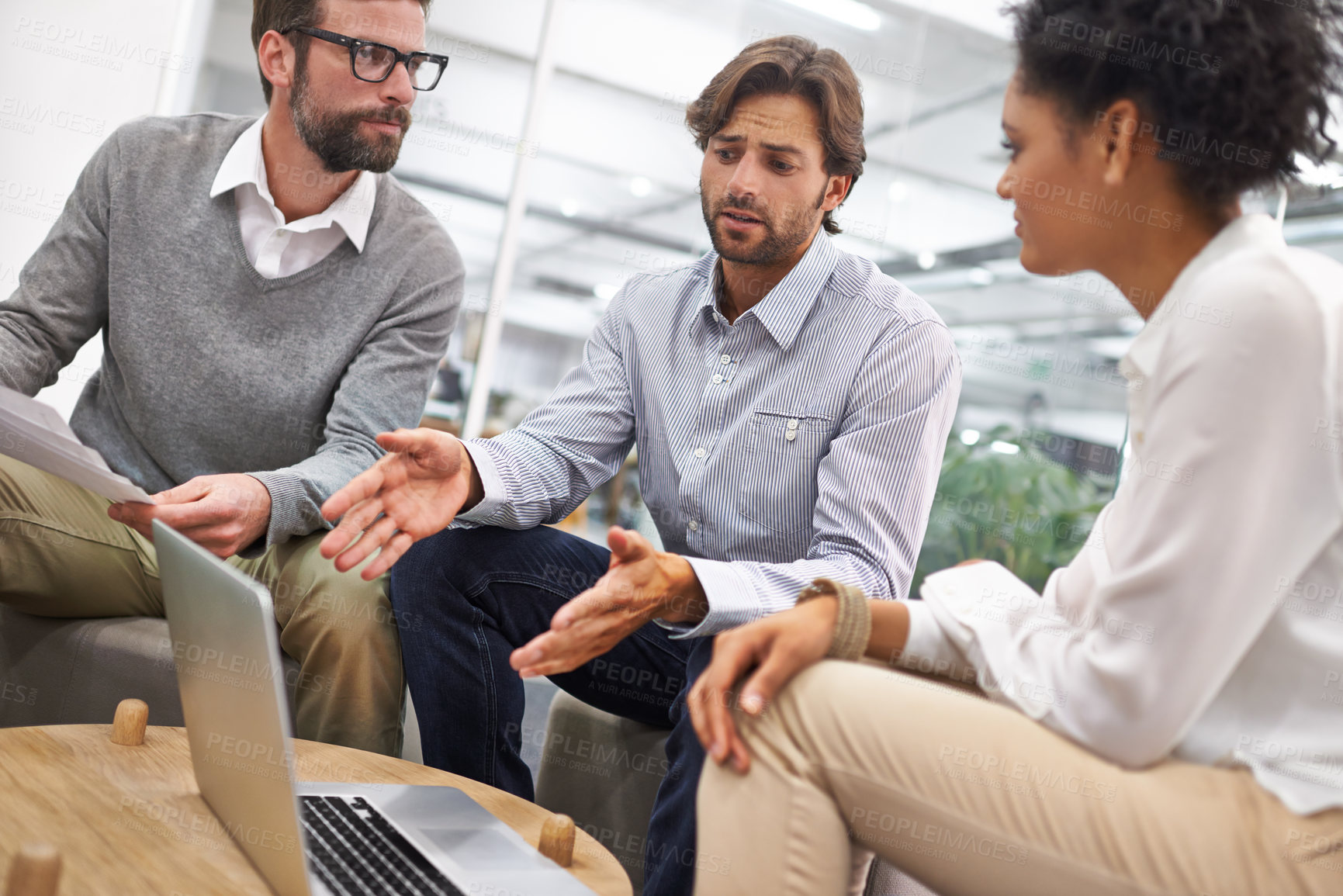 Buy stock photo Creative, teamwork and meeting or discussion with laptop in office for project planning and strategy review. Collaboration, employees and diversity with talking, startup or technology and listening