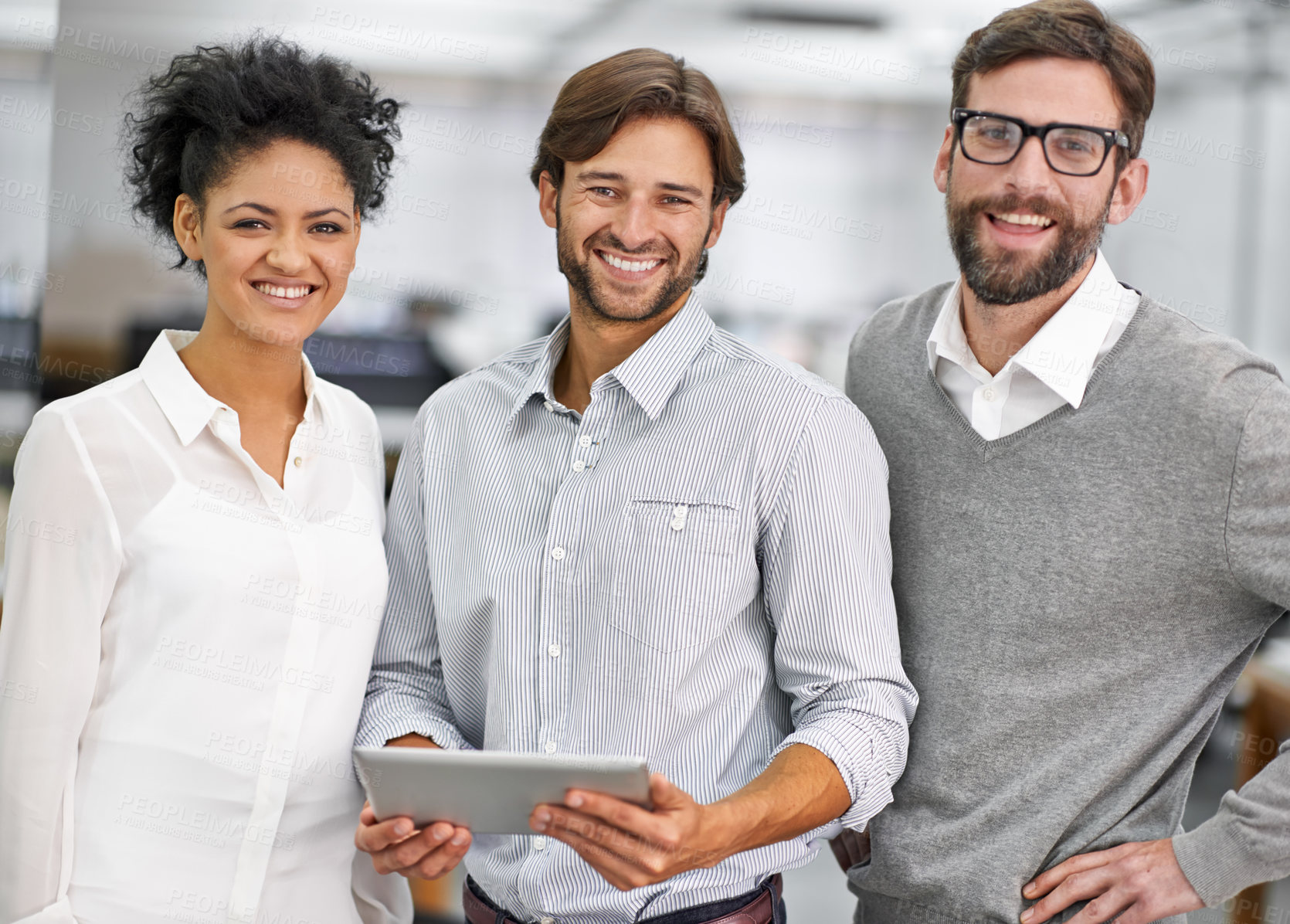 Buy stock photo Portrait of three young businesspeople standing in his office